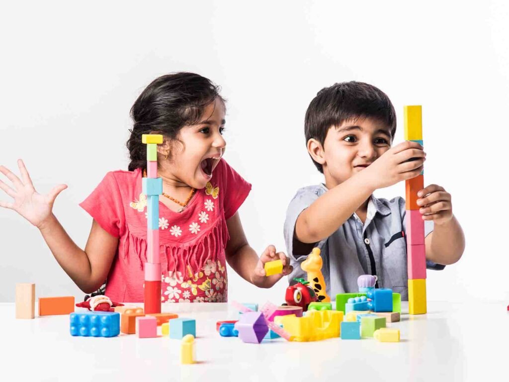 bnps jayanagar daycare 0005 cute little indian asian kids playing with colourful plastic toys blocks while sitting table
